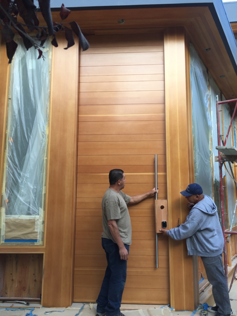 Large, wood front door with pivot function